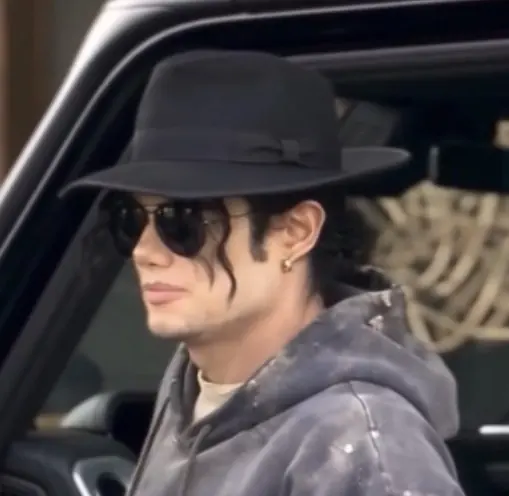 Michael character wearing a black fedora and sunglasses
